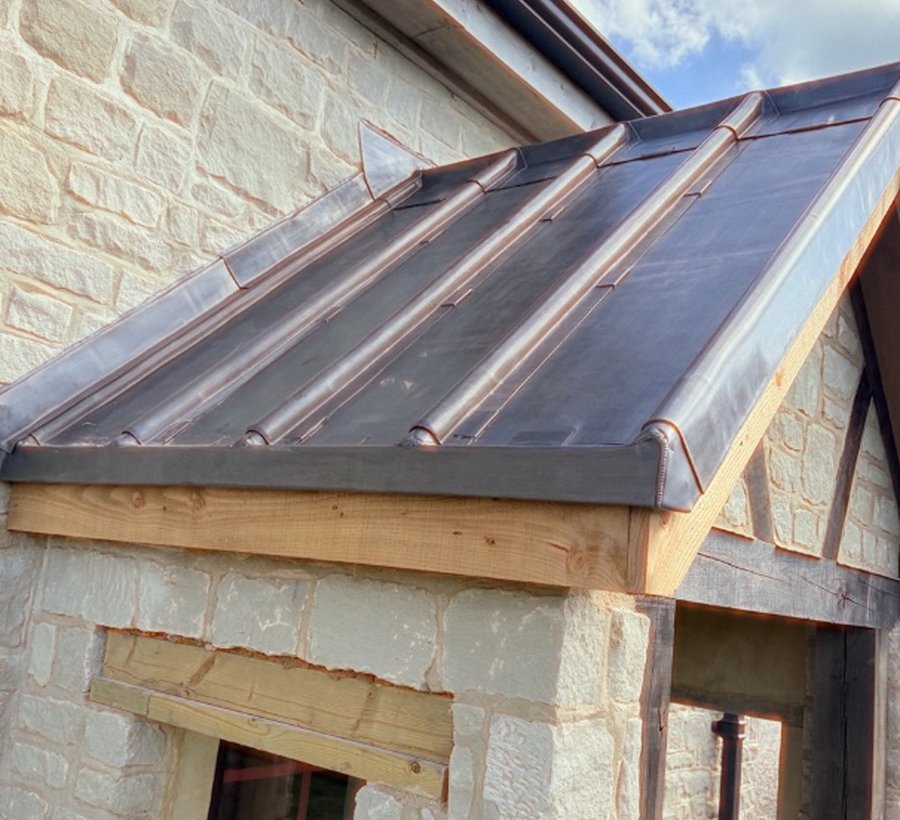 Standing seam metalwork on stone building