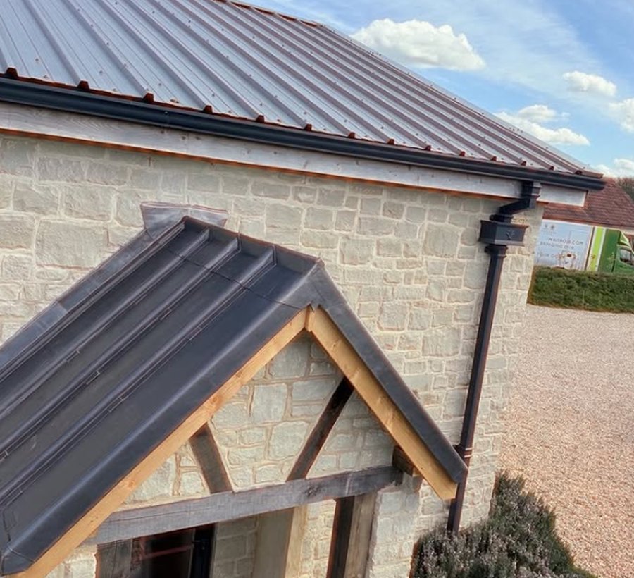 Standing-seam roof and porch on a stone home
